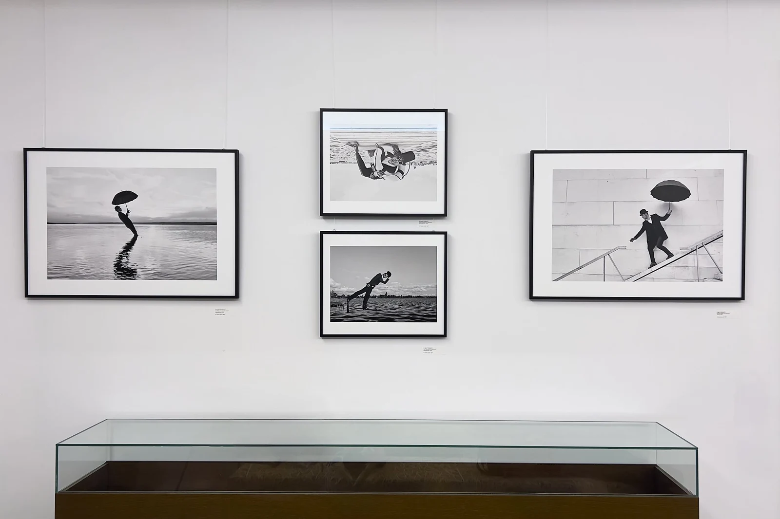 Framed black-and-white photographs from The Moments displayed on an exhibition wall.