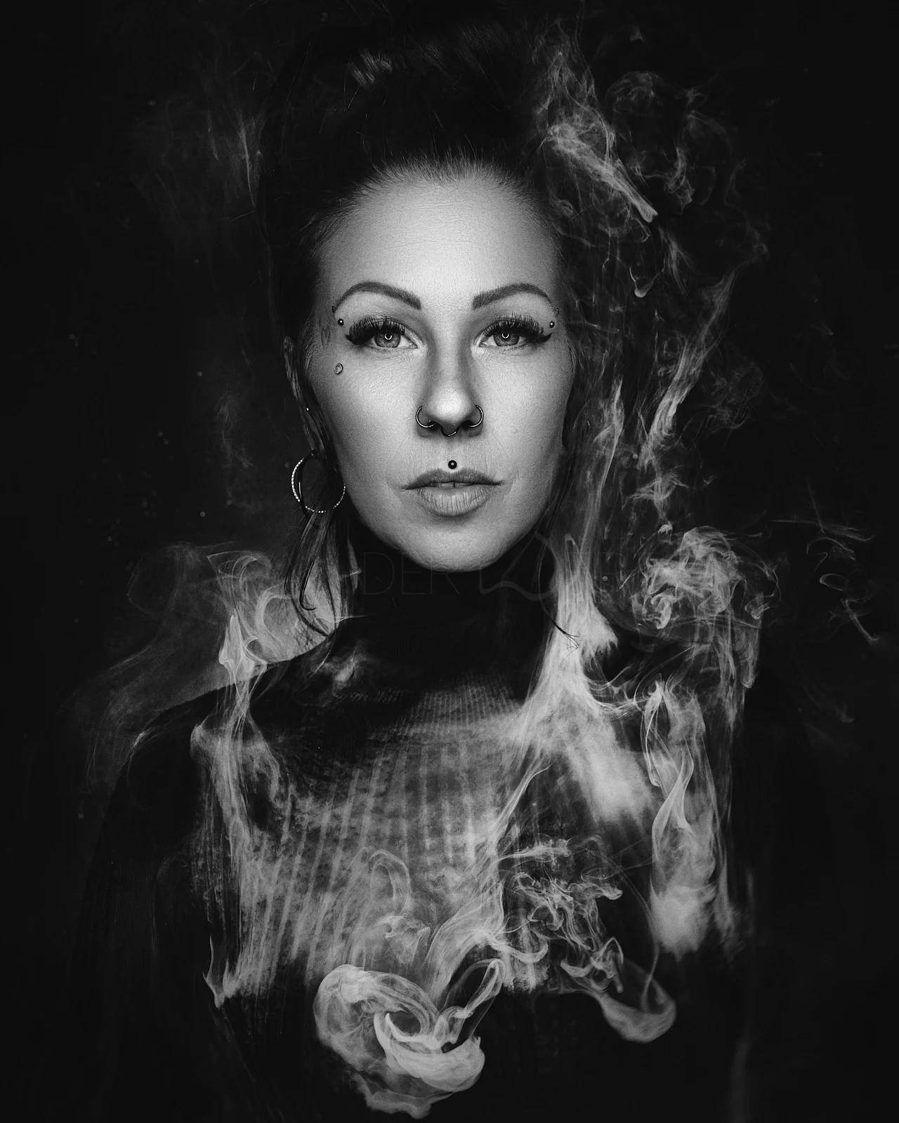 A woman's face emerging from a cloud of smoke.