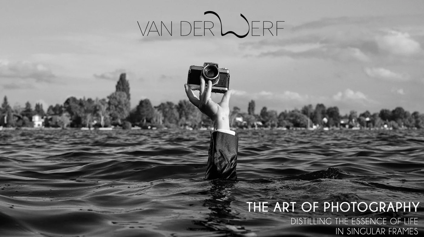 Person holding a camera above water, wearing a suit in a lake, with trees and houses in the background. Black and white photo. Text: 'Van Der Werf', 'The Art of Photography', 'Distilling the essence of life in singular frames'.