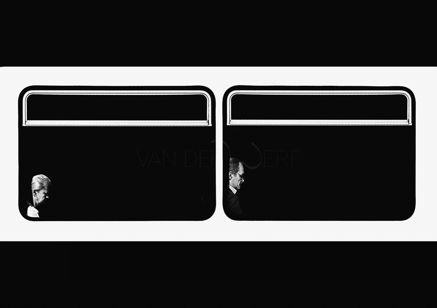 Black and white photo of two people seen through a train window, with their reflections visible on the glass in a dark setting.