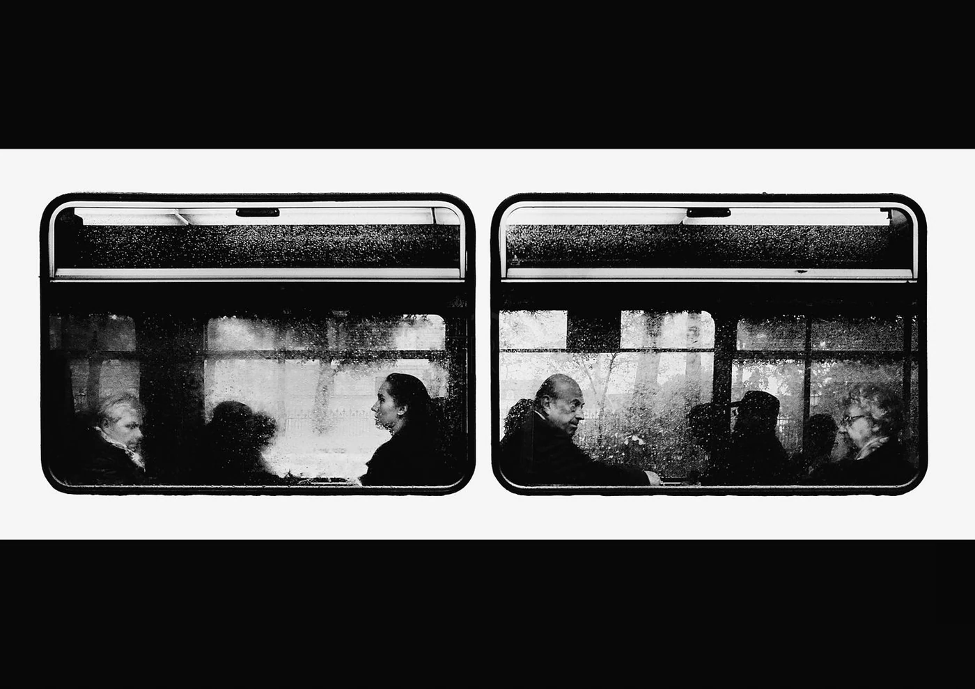Black and white photo of five people sitting on a bus, viewed through rain-covered windows, facing each other. Two women are on the left and three men are on the right.