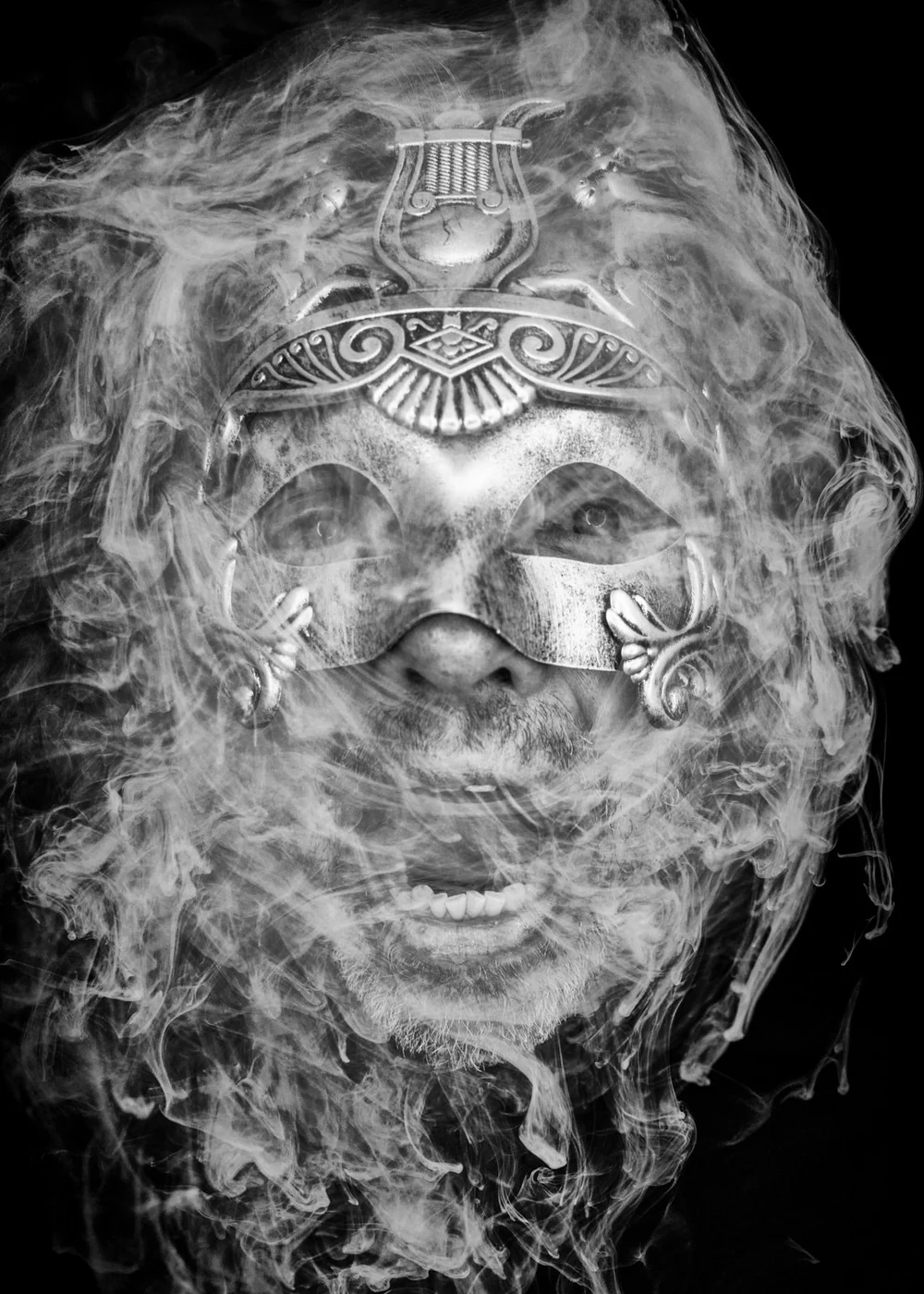 A person wearing a decorative mask with a metallic finish, partially obscured by swirling smoke or mist.